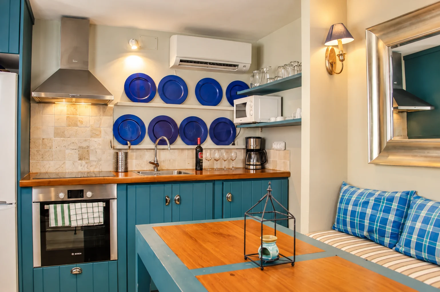 Blue kitchen at Villa Los Castaños with a wooden countertop