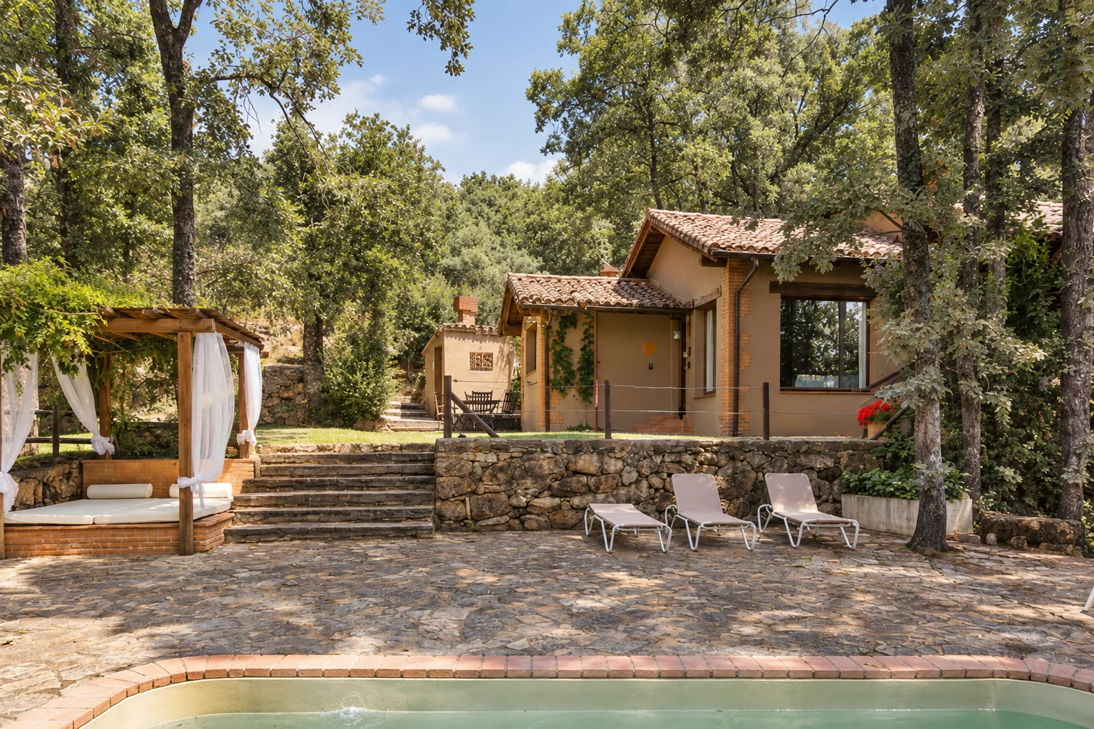 Pool, garden and facade of Villa Los Robles among the trees