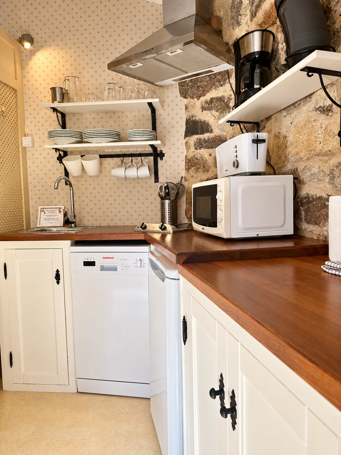 Kitchen of Villa Los Rosales with a wooden worktop and stone wall