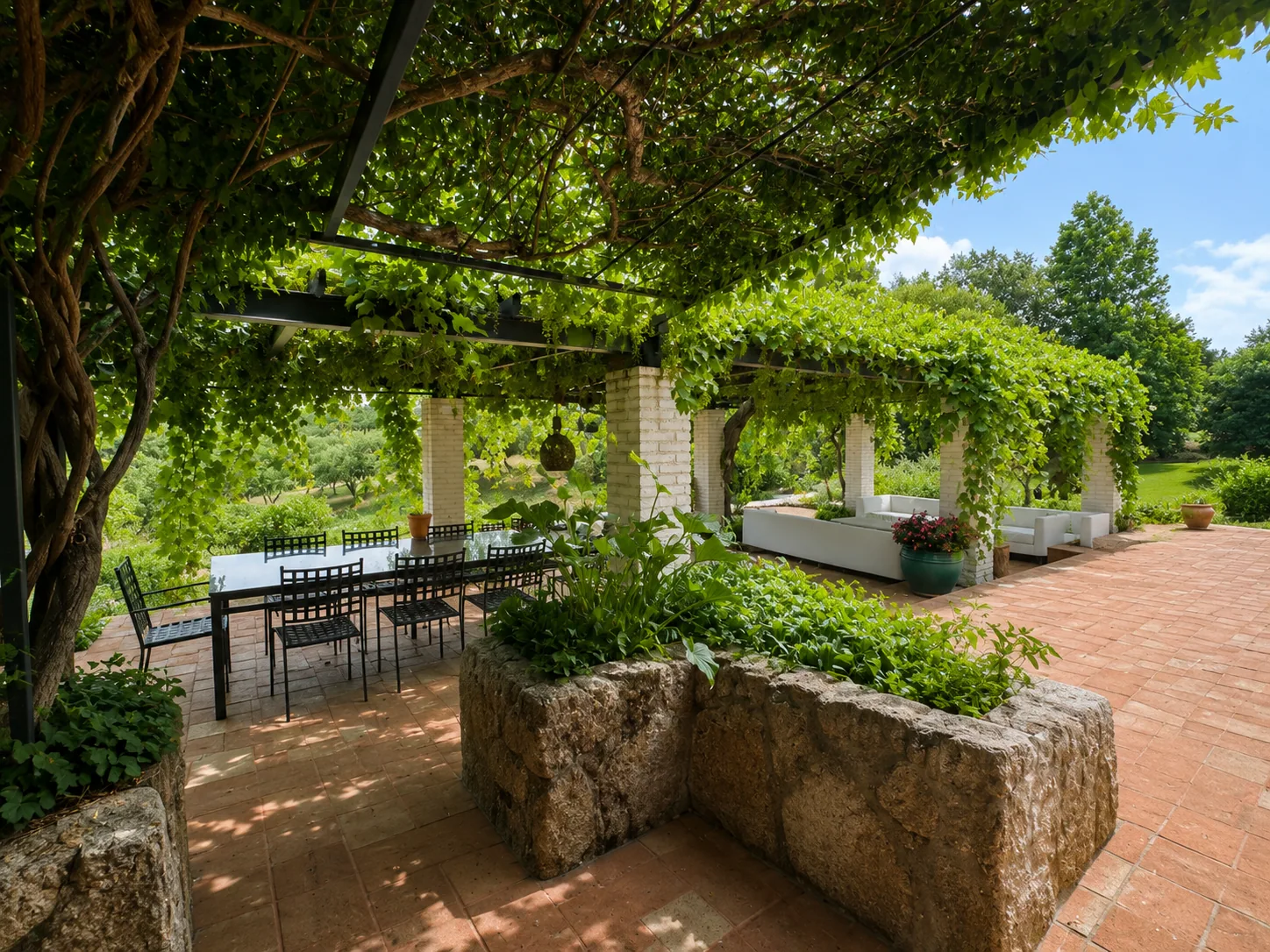 Outdoor dining area of Villa Alardos under the vine pergola