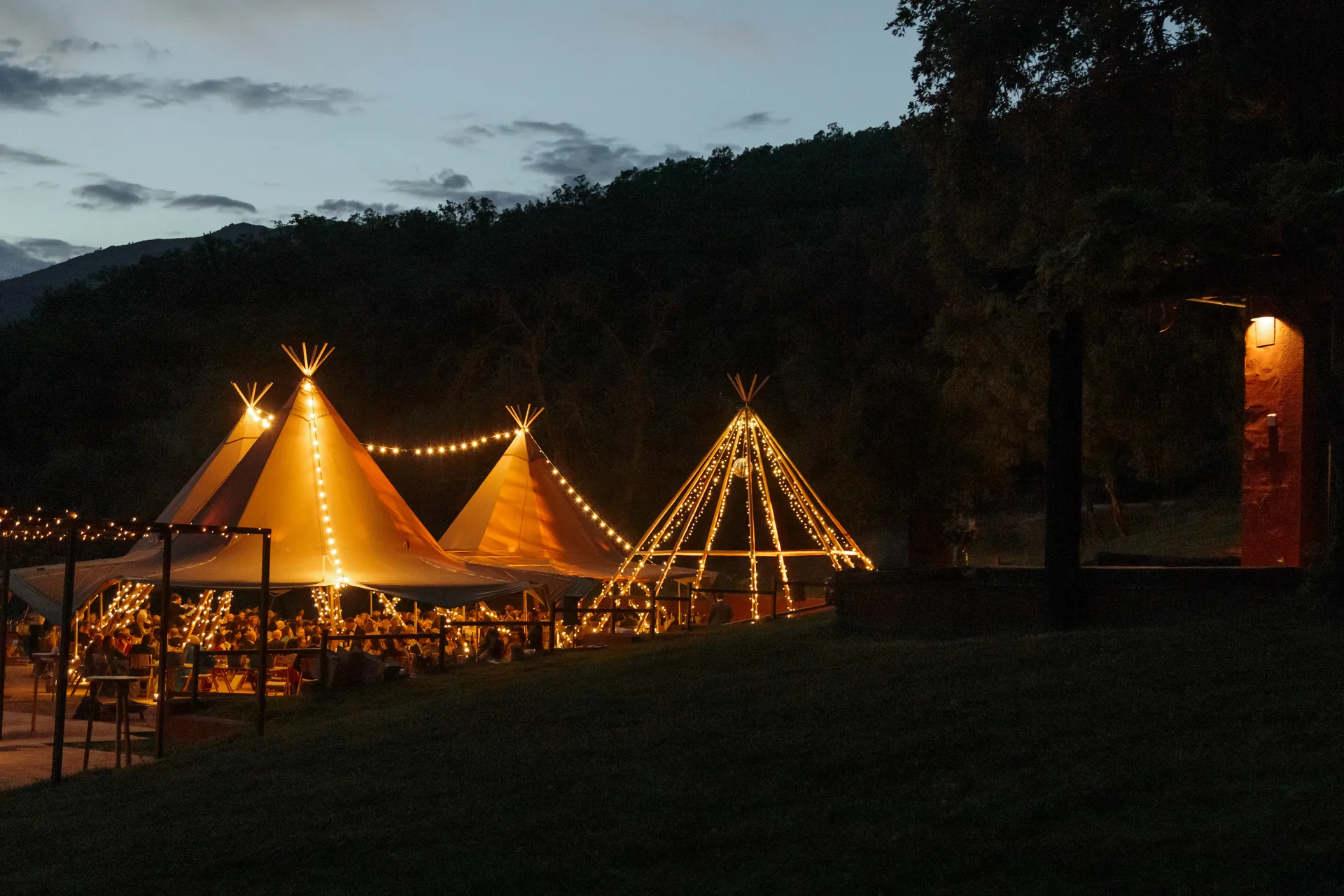 Wedding marquees illuminated at dusk at El Escondite