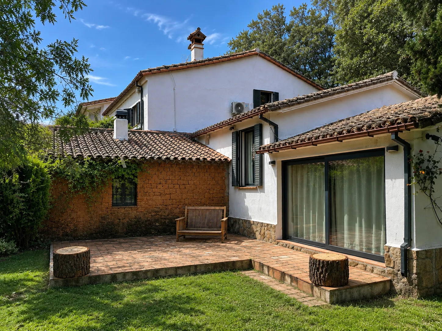 Rear terrace of Villa Alardos with windows onto the garden