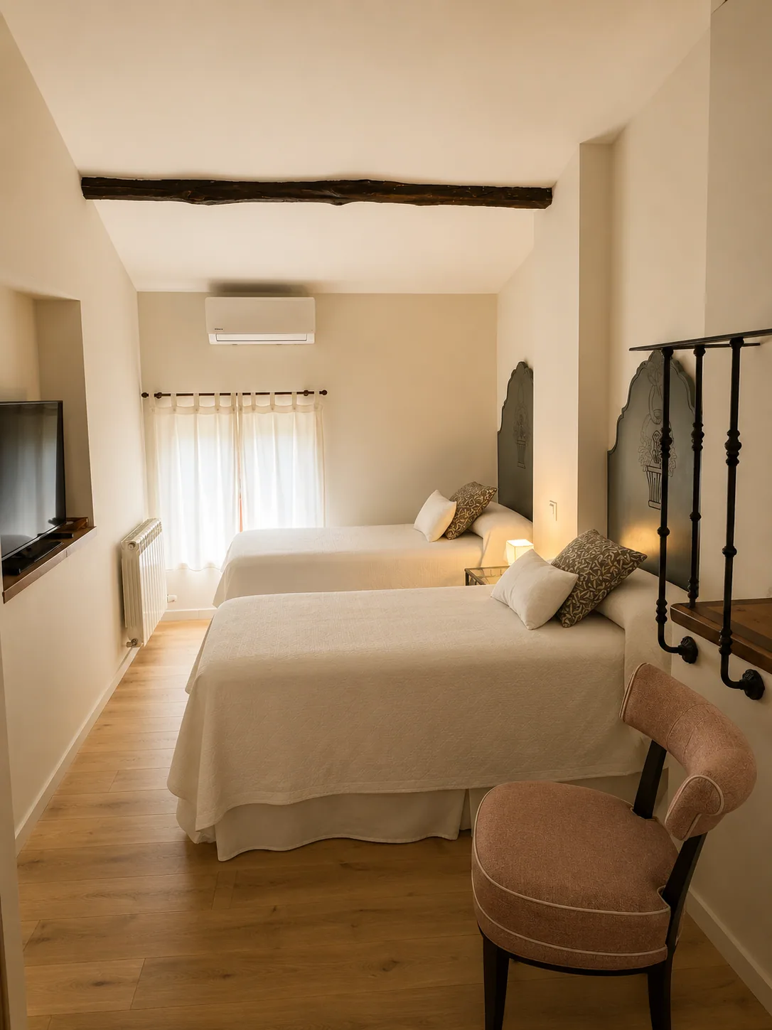 Bedroom of Villa Alardos with two beds and a television