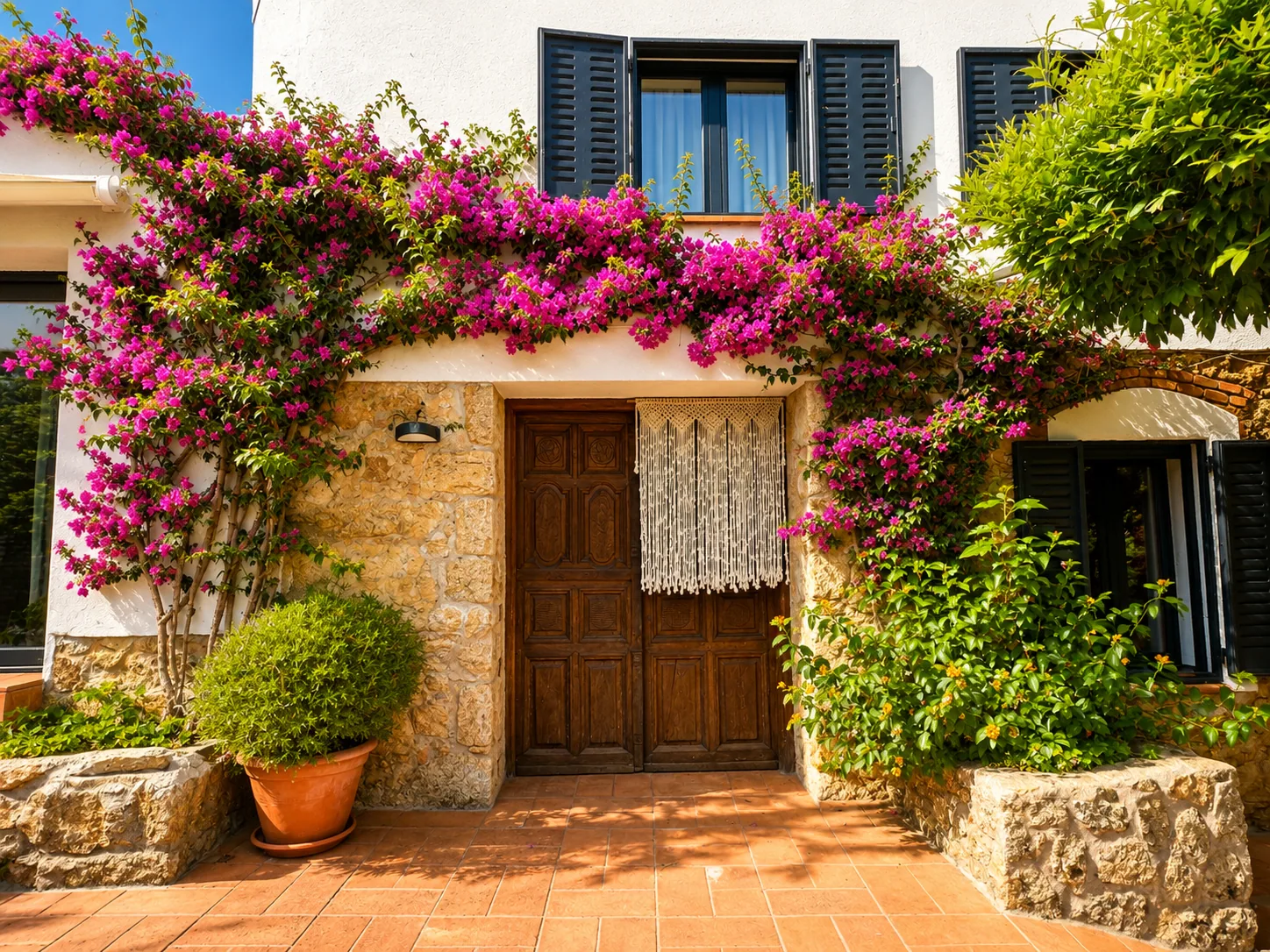 Wooden front door of Villa Alardos with bougainvillea in bloom