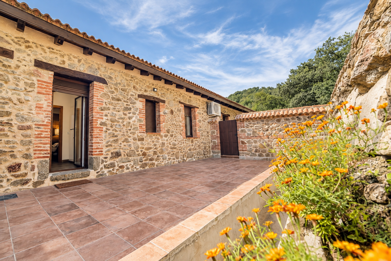 Stone facade and patio of Tomillo Apartment