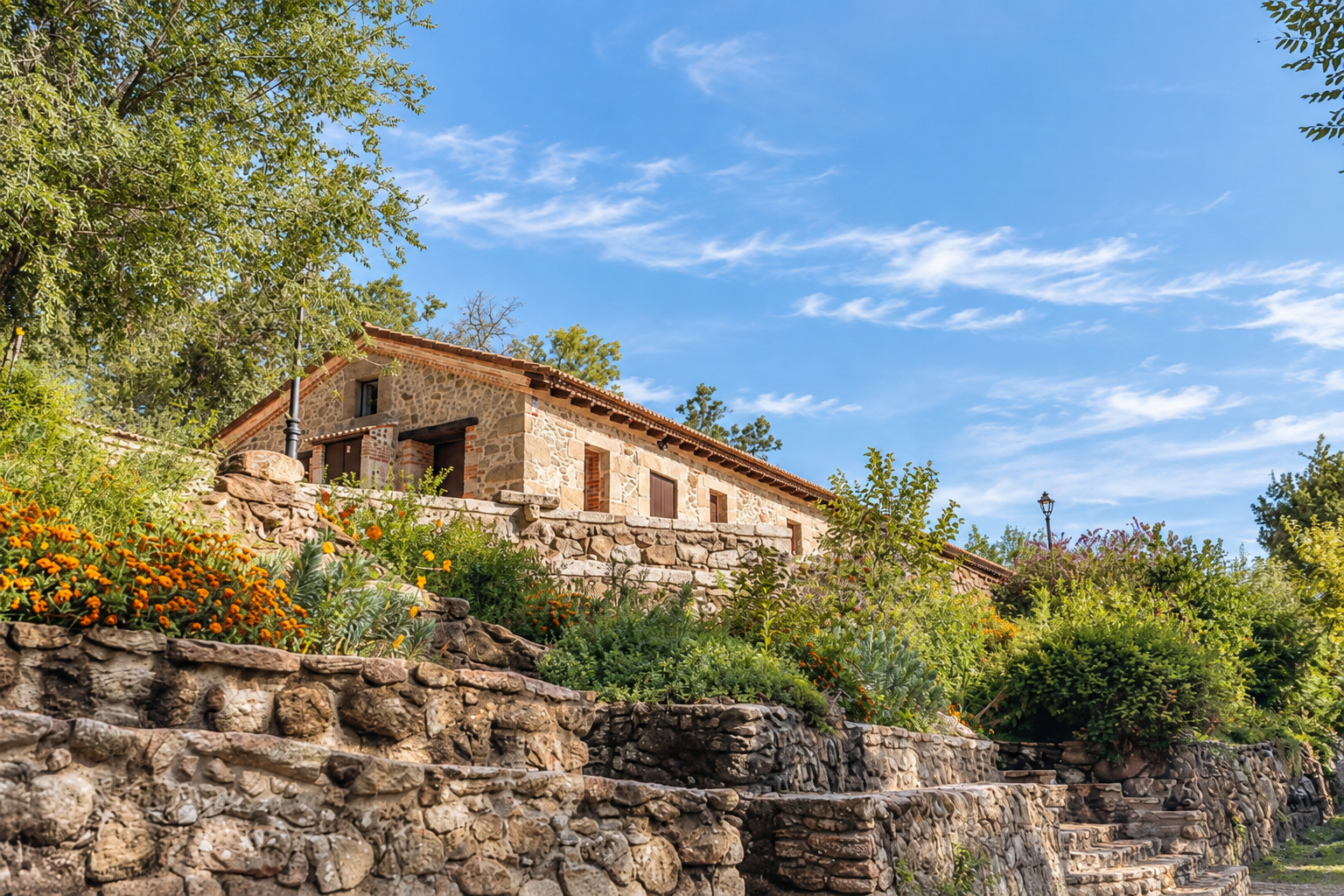 Stone facade of Tomillo Apartment among flowers and mountains