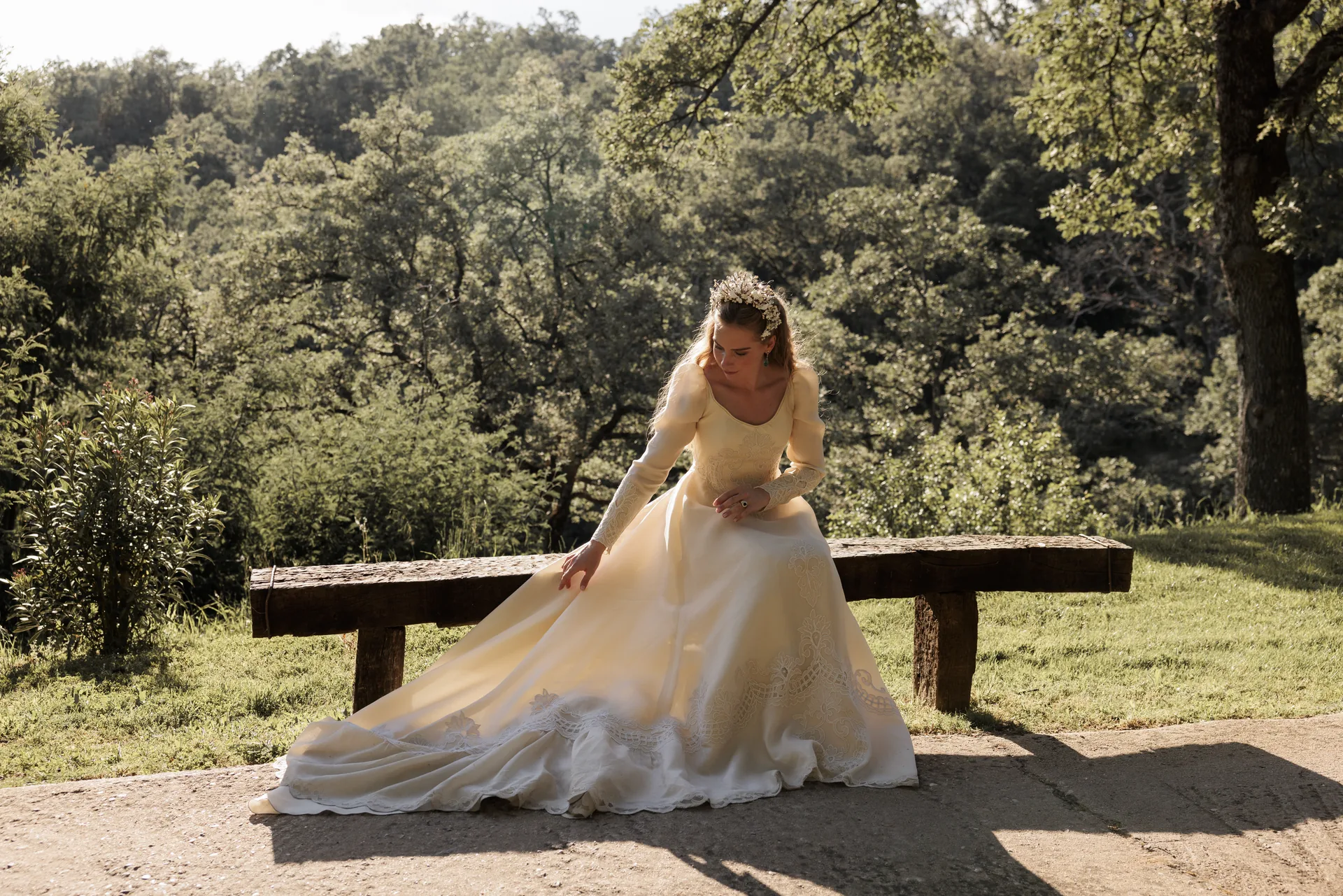 The bride rests by the estate's landscape after the celebration