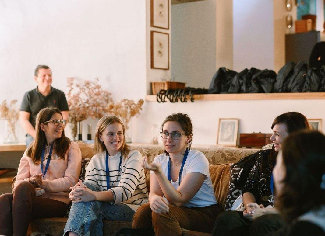 Work group seated in the living room of one of the houses