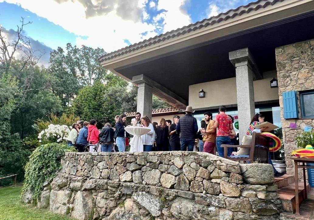 Group of people gathered on the stone terrace of one of the houses