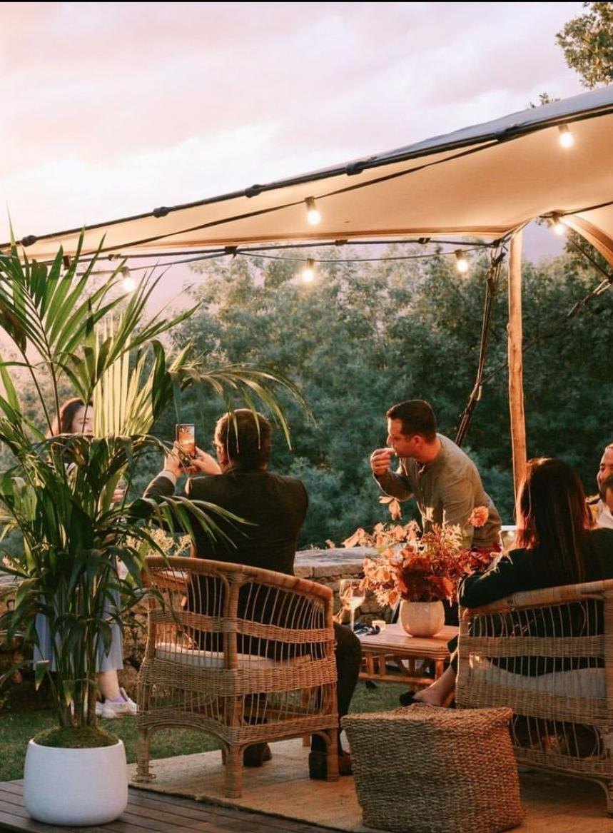 Group seated around a table on a house's porch