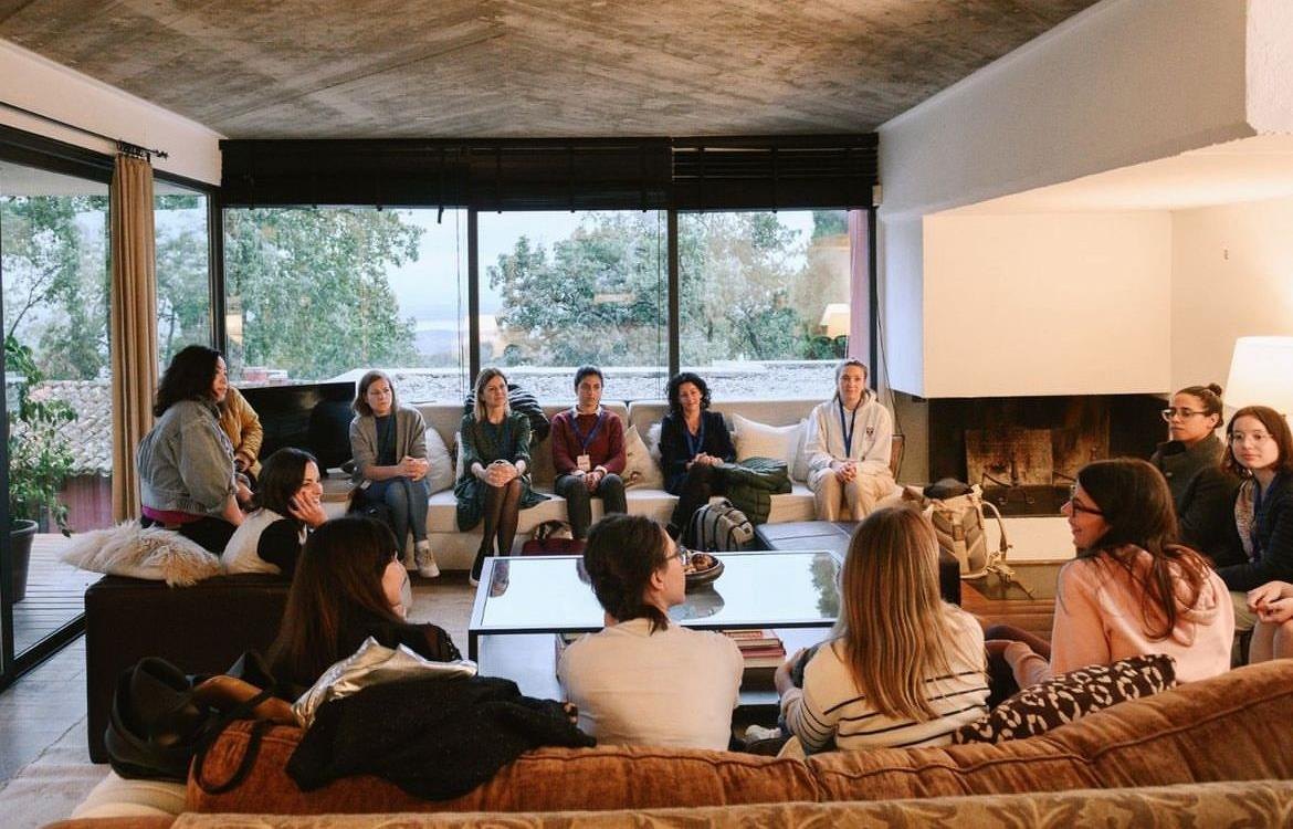 Team gathered in the glass-walled living room of one of the estate's houses